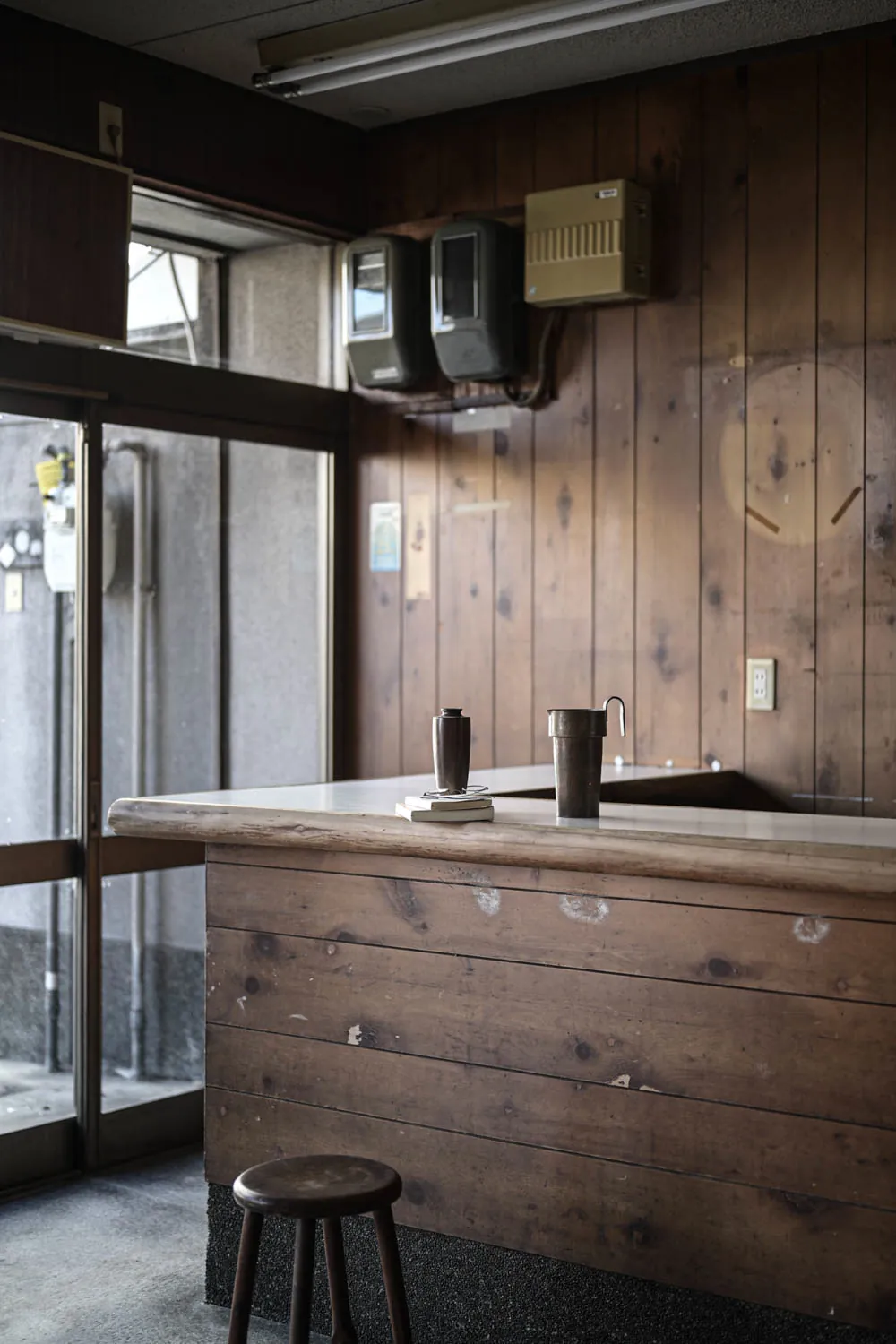 An old wooden counter by the street windows, as found.