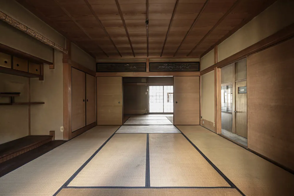 A long upstairs tatami room, doors open through to the next.